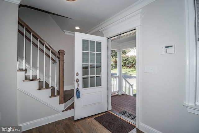 entryway with crown molding and dark hardwood / wood-style floors