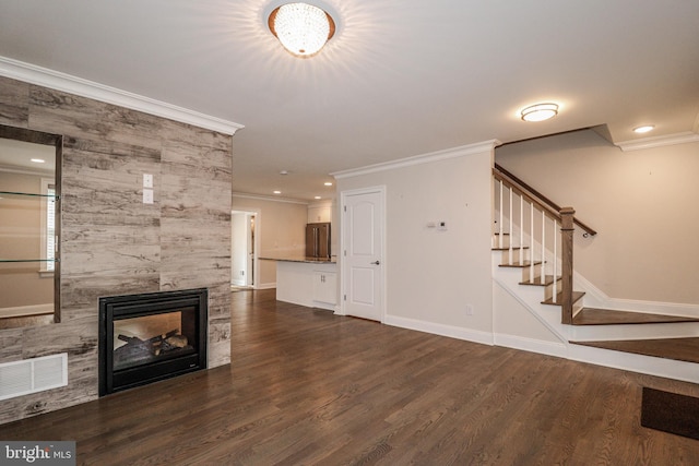 unfurnished living room with a fireplace, ornamental molding, and dark wood-type flooring