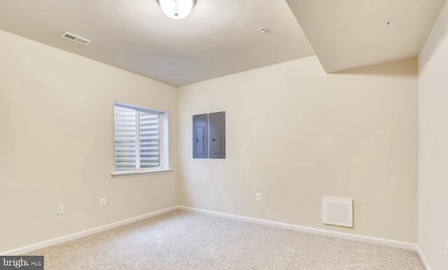 unfurnished room featuring electric panel and light colored carpet