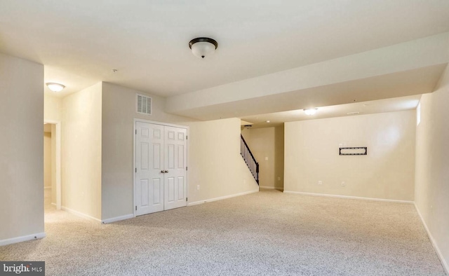 basement featuring light carpet