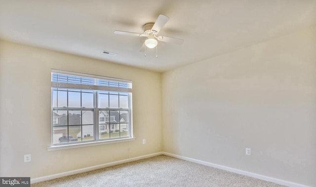 spare room featuring carpet flooring and ceiling fan