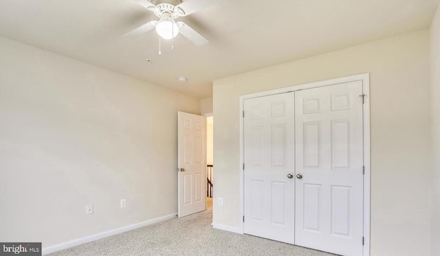 unfurnished bedroom with a closet, ceiling fan, and light carpet