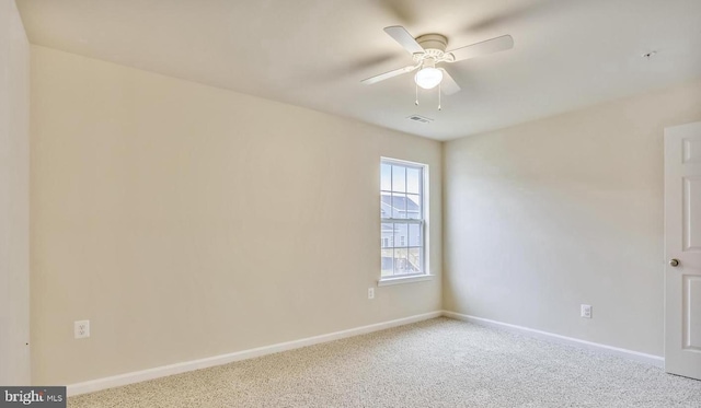 carpeted spare room with ceiling fan