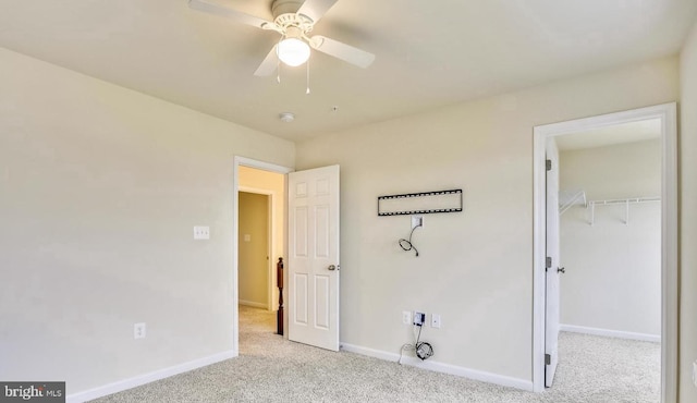 unfurnished bedroom with a closet, ceiling fan, and light colored carpet