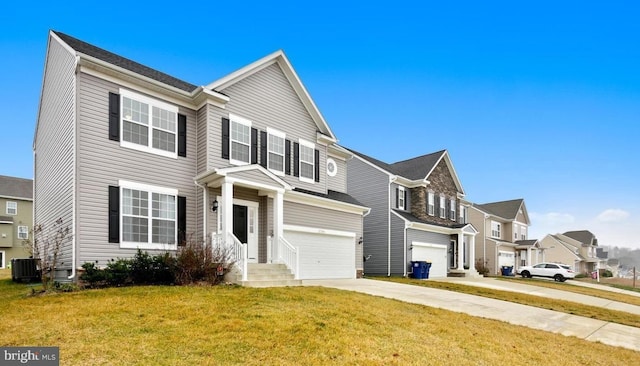 view of front of property featuring a front lawn, cooling unit, and a garage