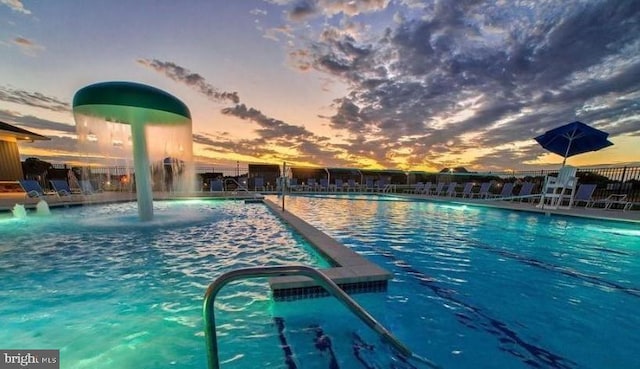 pool at dusk with pool water feature