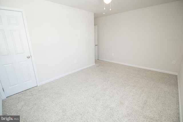 empty room with carpet floors and ceiling fan