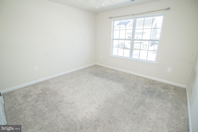 carpeted empty room featuring ceiling fan