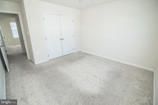 unfurnished bedroom featuring a closet and carpet floors