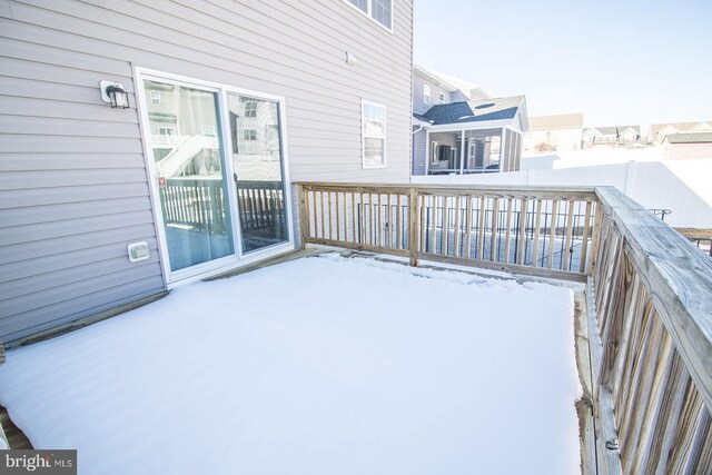 view of snow covered back of property