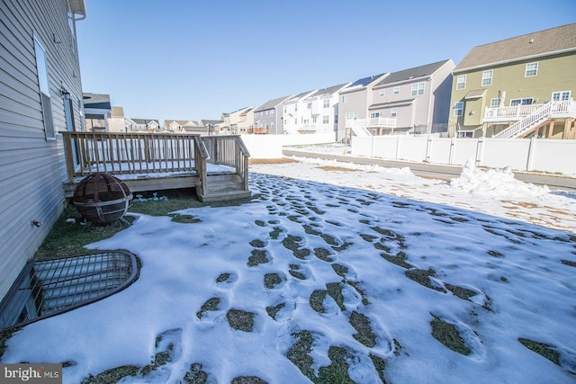 snowy yard with a wooden deck