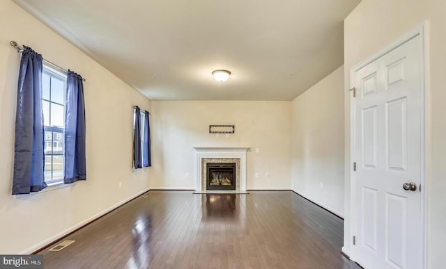 unfurnished living room with dark wood-type flooring