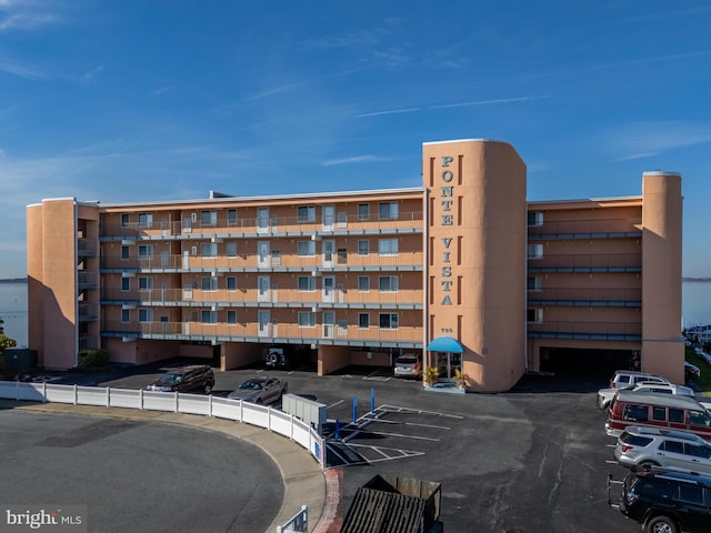 view of building exterior featuring uncovered parking