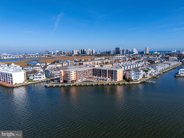 birds eye view of property with a view of city and a water view