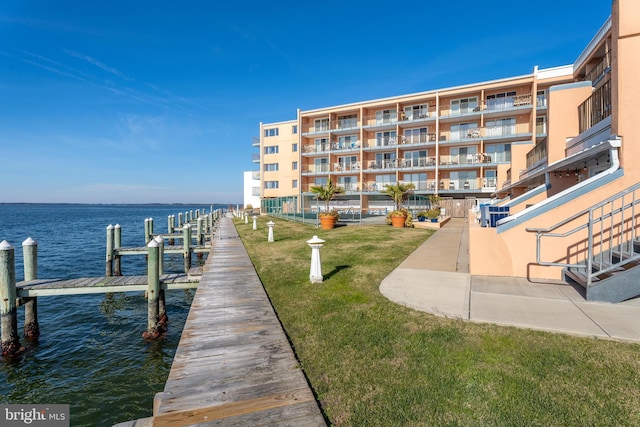 dock area with a yard and a water view