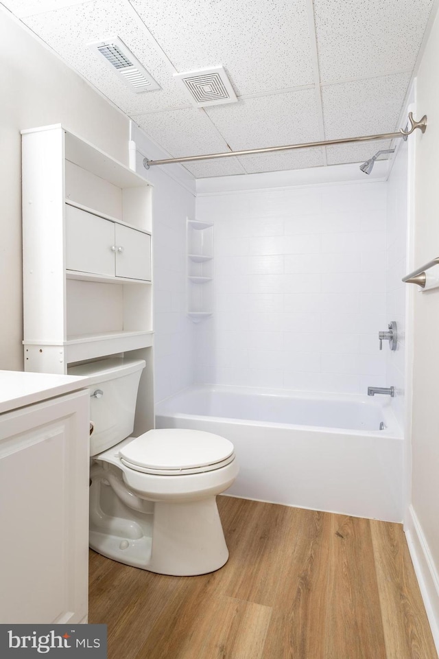 full bath featuring visible vents, toilet, and wood finished floors