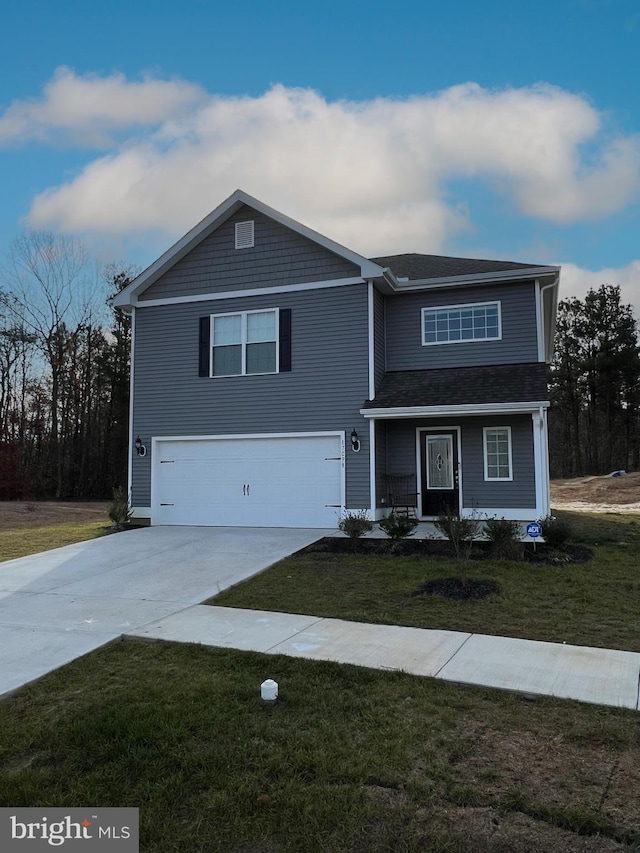 view of front of home featuring a garage and a front yard