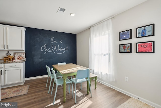 dining area with wood-type flooring