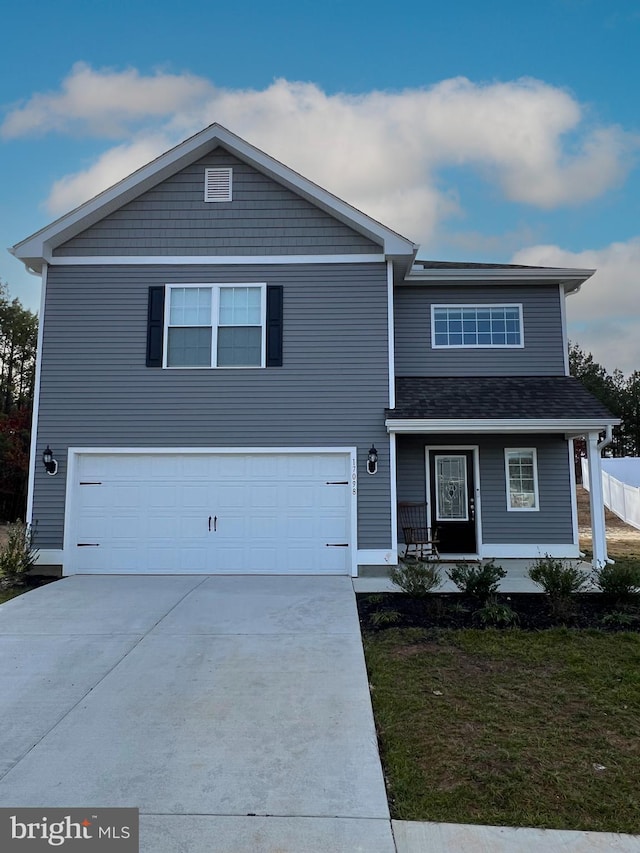 view of front of house featuring a porch, a garage, and a front lawn