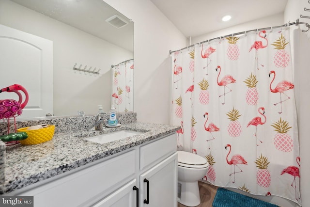 bathroom featuring vanity, hardwood / wood-style flooring, toilet, and curtained shower