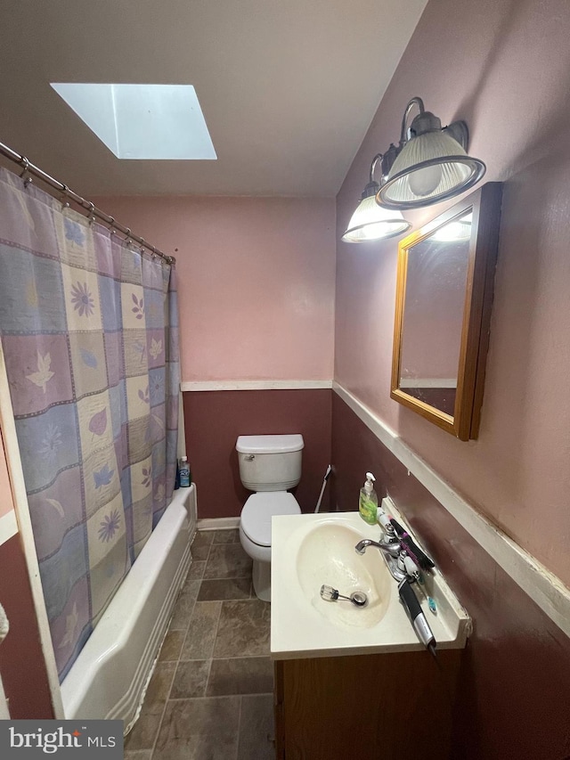 full bathroom with vanity, toilet, shower / bathtub combination with curtain, and a skylight