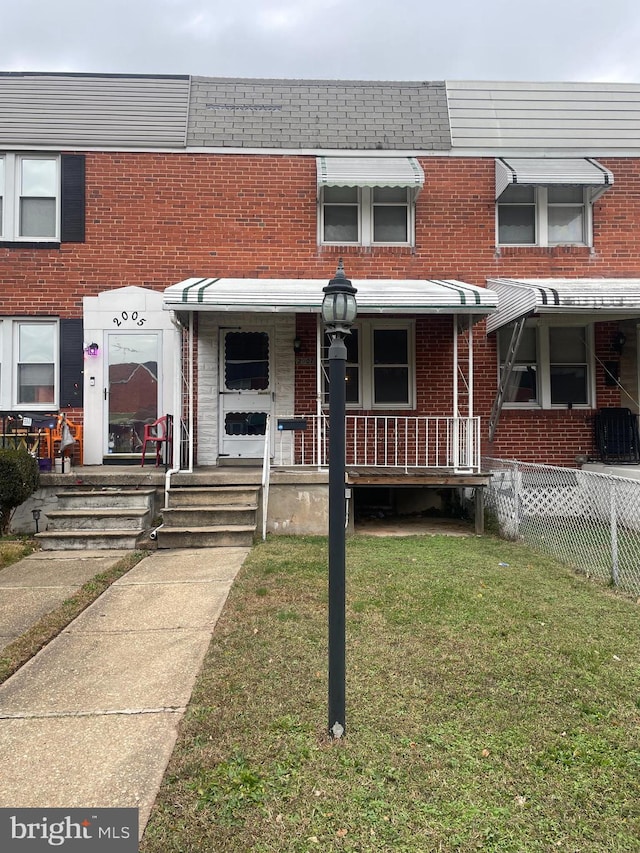 view of property featuring a front yard and central AC