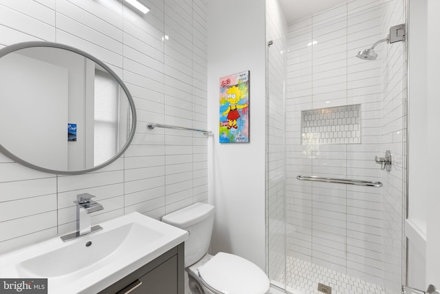 bathroom featuring vanity, decorative backsplash, toilet, walk in shower, and tile walls