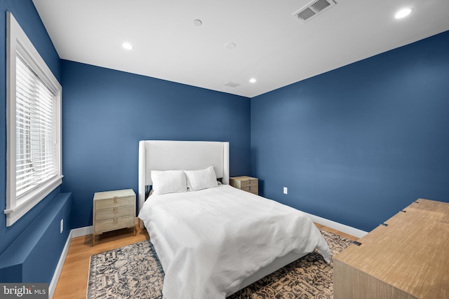 bedroom with hardwood / wood-style floors