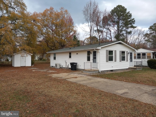 exterior space with a yard and a storage unit