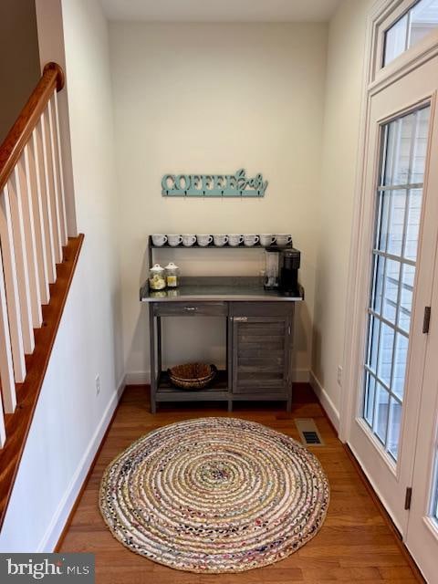 bar featuring dark wood-type flooring