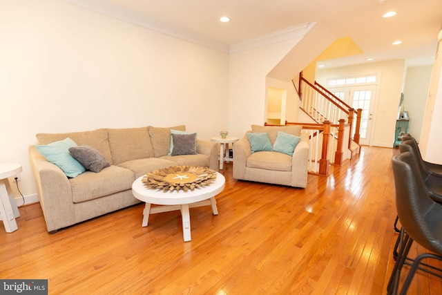 living room featuring hardwood / wood-style floors and ornamental molding