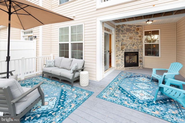 view of patio / terrace with an outdoor living space with a fireplace