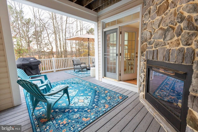 wooden terrace featuring a grill and french doors