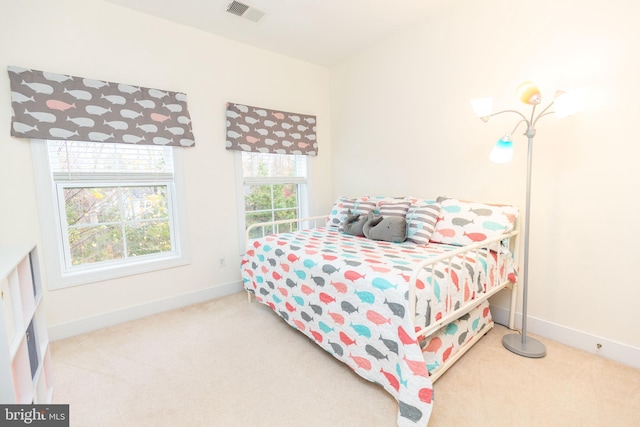 bedroom featuring carpet floors and multiple windows