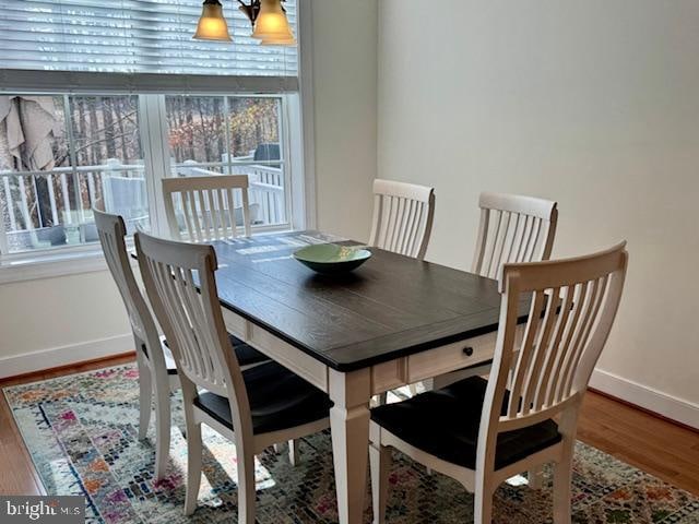 dining space with wood-type flooring