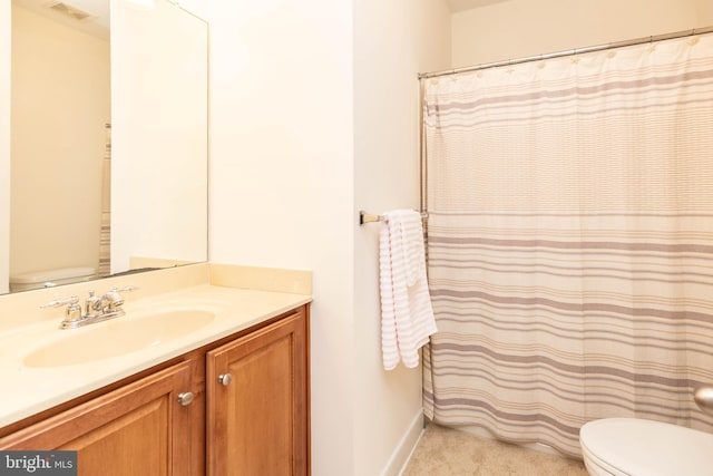 bathroom featuring vanity and toilet