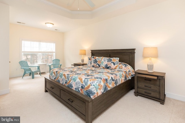 carpeted bedroom featuring a raised ceiling, ceiling fan, and ornamental molding