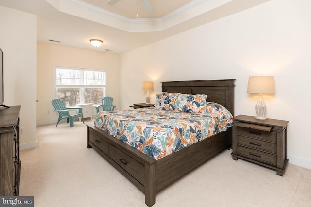 bedroom with light colored carpet, a raised ceiling, ceiling fan, and crown molding