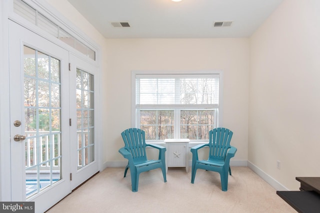 living area with light colored carpet and a wealth of natural light