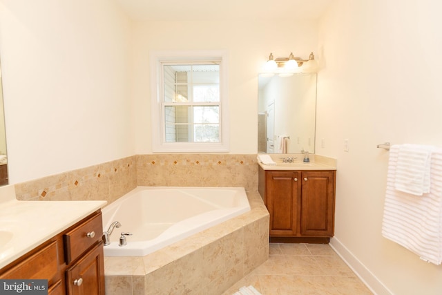 bathroom featuring tiled bath, tile patterned flooring, and vanity