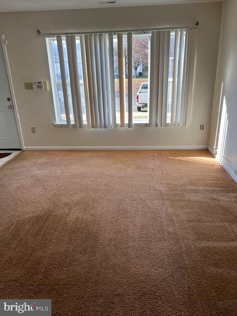 unfurnished room with light carpet