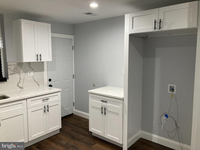 kitchen with white cabinetry and dark hardwood / wood-style flooring