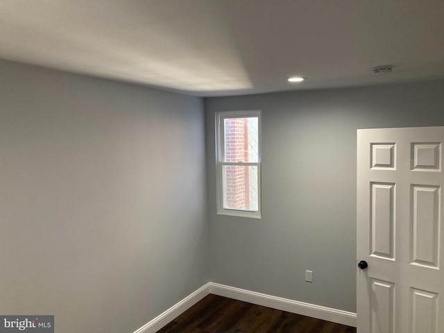 empty room featuring dark hardwood / wood-style flooring