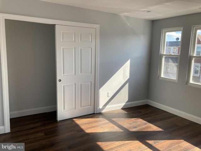 unfurnished room featuring dark hardwood / wood-style flooring