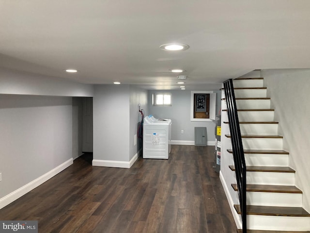 basement featuring washer / clothes dryer and dark wood-type flooring