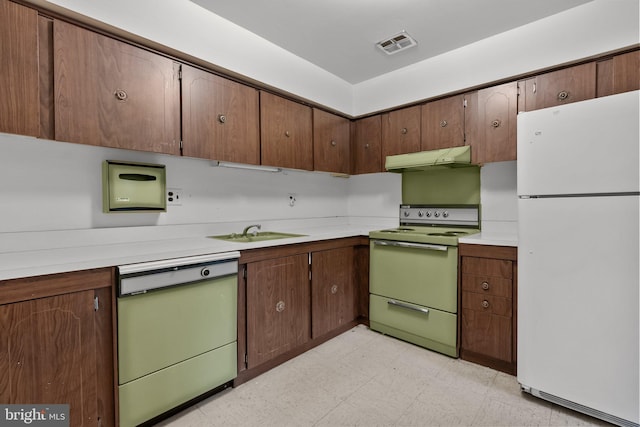 kitchen featuring white appliances and sink