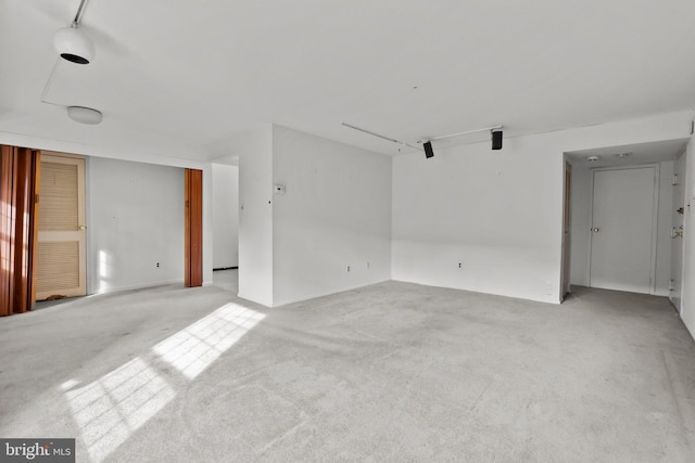 spare room featuring light colored carpet