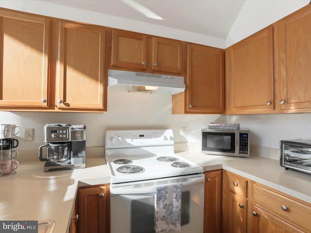 kitchen featuring vaulted ceiling and white electric stove