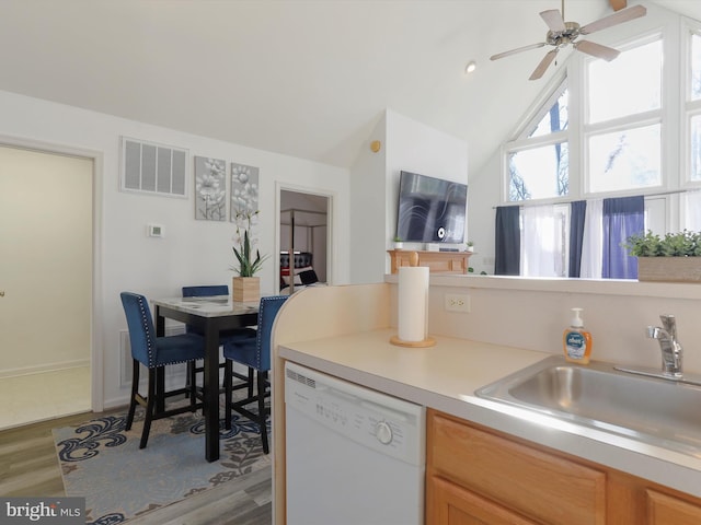 kitchen with ceiling fan, sink, hardwood / wood-style flooring, dishwasher, and lofted ceiling