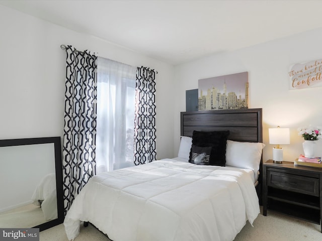 bedroom with light colored carpet